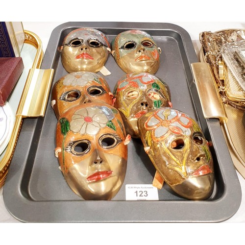 123 - Six brass wall masks, length 12.5cm. In house shipping available excluding the United States of Amer... 