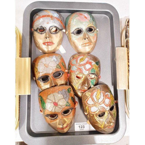 123 - Six brass wall masks, length 12.5cm. In house shipping available excluding the United States of Amer... 