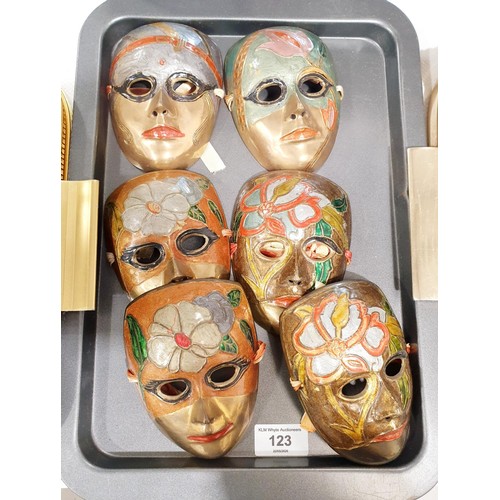 123 - Six brass wall masks, length 12.5cm. In house shipping available excluding the United States of Amer... 