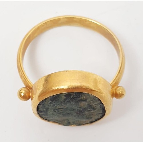 10 - A 14ct gold ring set with an ancient Greek bronze coin, gross weight 6.12g, size O. In house shippin... 