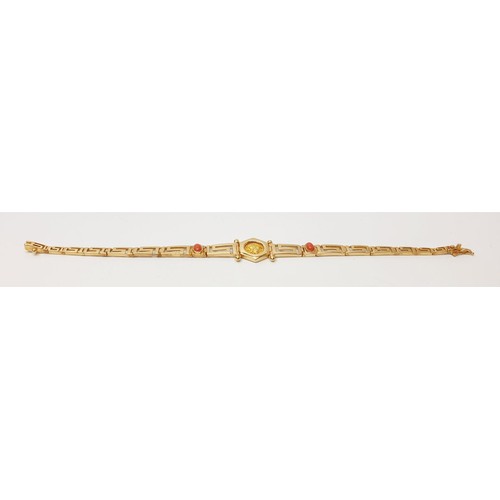 12 - A 14ct gold Greek key motif bracelet, with a central captive gold coin and two coral cabochons, leng... 