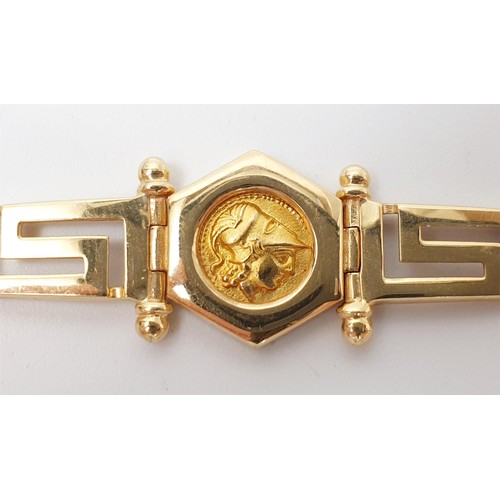 12 - A 14ct gold Greek key motif bracelet, with a central captive gold coin and two coral cabochons, leng... 