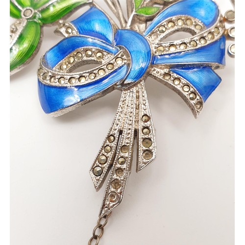 23 - A white metal and enamel brooch in the form of a flower set with marcasite A/F, gross weight 23g. In... 