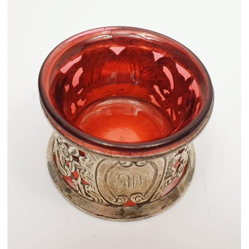 34 - An Irish hallmarked silver potato ring, diameter 5.5, married with a cranberry glass salt liner, Dub... 