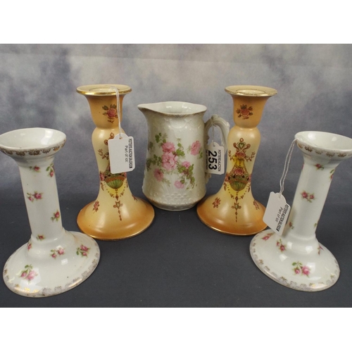 253 - Pair of Turn of the century blushware candlesticks together with floral patterned candlesticks & jug