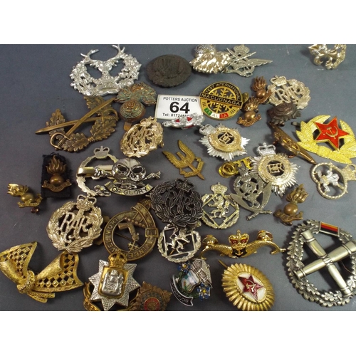 64 - Selection of reproduction military cap badges.