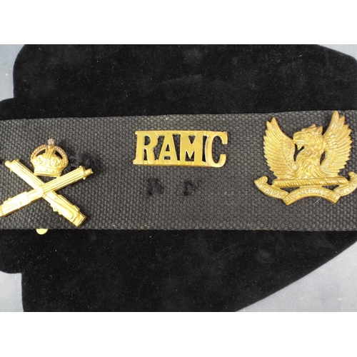 12 - A Navy Webbing Belt with 14 Regimental Cap badges attached.. WW1 MGC badge not original