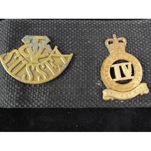 12 - A Navy Webbing Belt with 14 Regimental Cap badges attached.. WW1 MGC badge not original