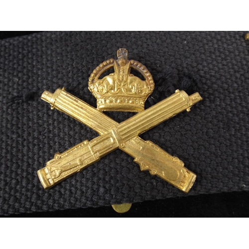 12 - A Navy Webbing Belt with 14 Regimental Cap badges attached.. WW1 MGC badge not original