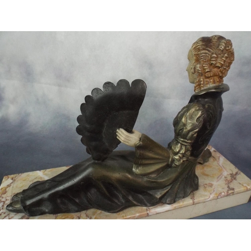 134 - Deco Era spelter figure of a reclining lady on solid marble base