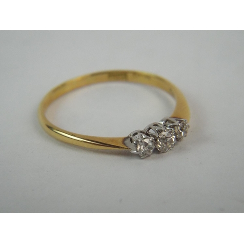 118 - 18ct Gold ring set with Three diamonds.  2.0g  finger Size Q5