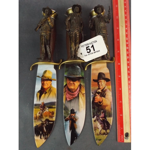 51 - Three commemorative John Wayne knives by Bradford Exchange.