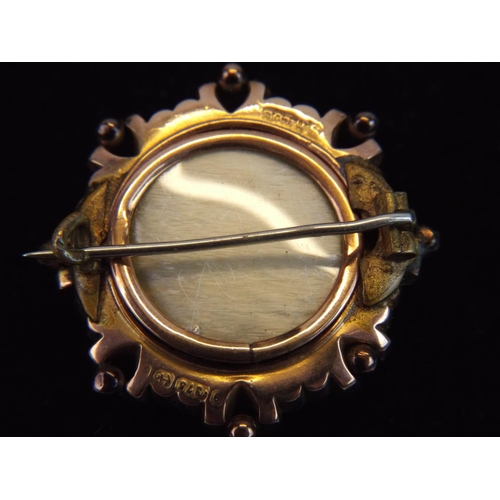 130 - 9ct gold Shield Brooch set with small central pearl. Locket to rear of brooch. 4.6g.