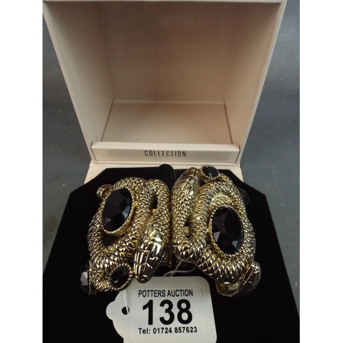 138 - As new in box, chunky snake bracelet set with dark stones. Magnetic spring clasp.