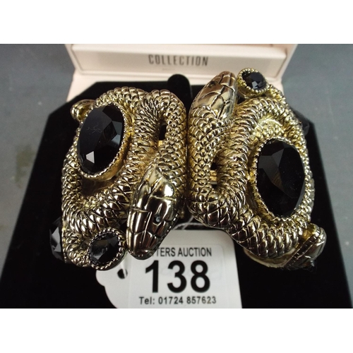 138 - As new in box, chunky snake bracelet set with dark stones. Magnetic spring clasp.