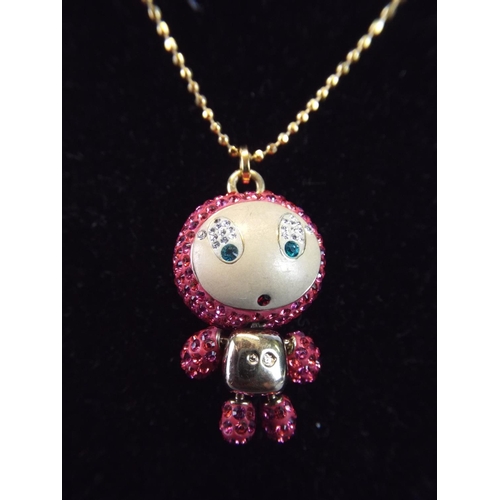 92 - Swarkovski articulated Doll Pendant on a 34 inch gilt metal chain.