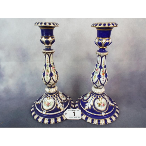 1 - A Pair of antique porcelain candlesticks with applied flowers and gilding slight a/f to one