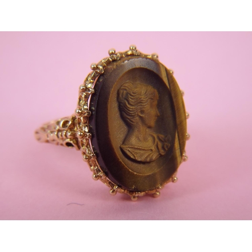 37 - 9ct Gold, carved tiger's eye set cameo ring. Finger size 'O5' 6.7g