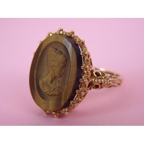 37 - 9ct Gold, carved tiger's eye set cameo ring. Finger size 'O5' 6.7g