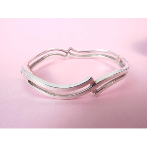 63 - 925 Hallmarked silver crossover bracelet.