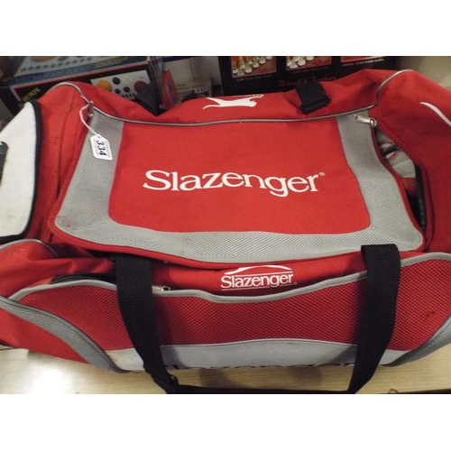 334 - Large Slazenger bag filled with cricket equipment