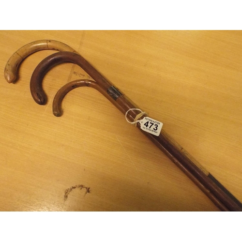 473 - Three vintage walking canes, one with silver collar.