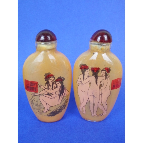 12 - Two chinese glass perfume bottles with erotic motifs.