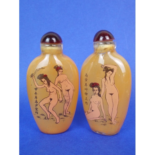 12 - Two chinese glass perfume bottles with erotic motifs.