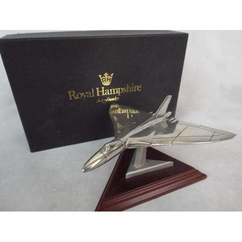 107 - A solid Pewter model of a Vulcan Bomber on wooden plinth & original box. 4.5 inch wingspan