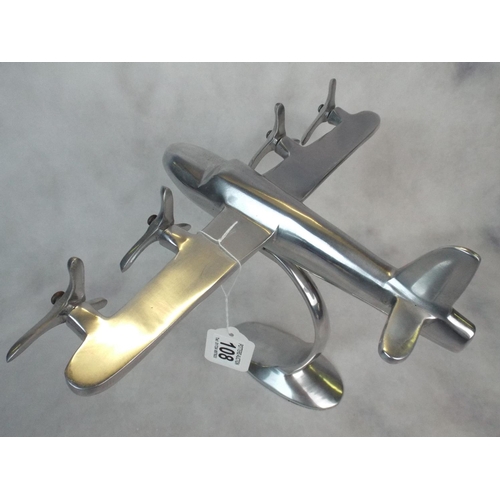 108 - A solid Aluminium four engined desk model plane. 12 inch wingspan.