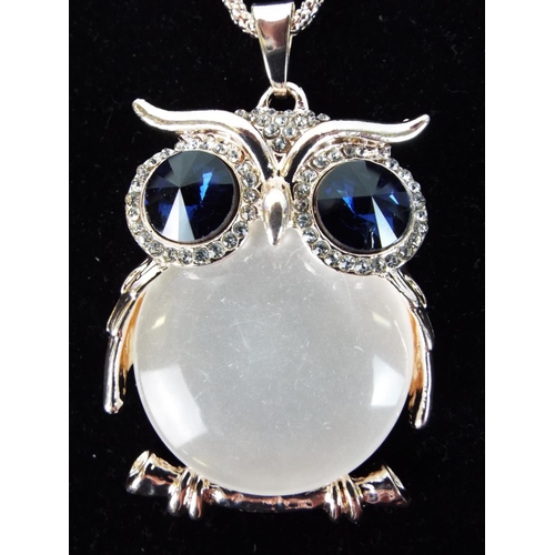 115 - Large owl pendant on white metal chain. As new and unused