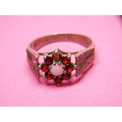 121 - Opal and Garnet set silver ring.