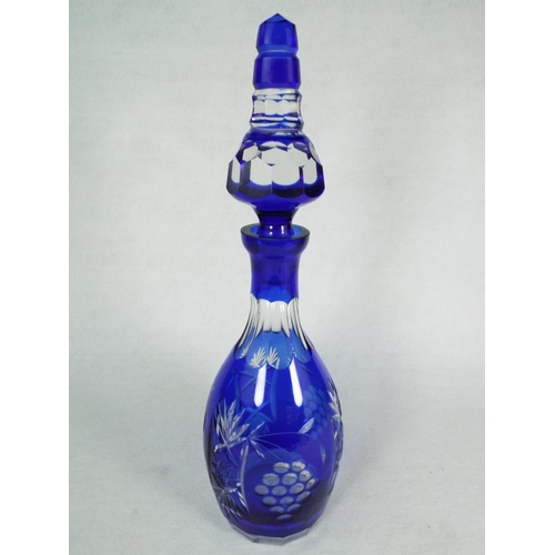 33 - Large Bohiemian Blue glass decanter with matching stopper. 14 inches tall.