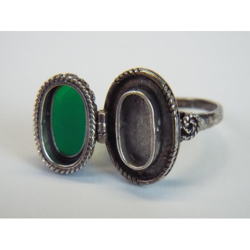 68 - Hallmarked silver poison ring with green hinged stone and scrolled shoulders, finger size P5