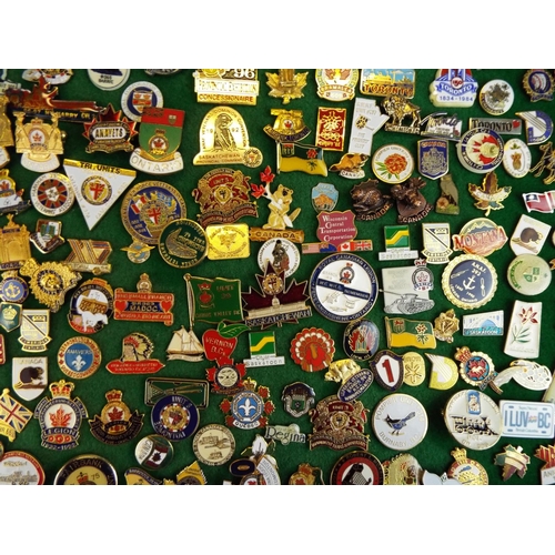 58 - Large Mounted Display of metal and enamel badges