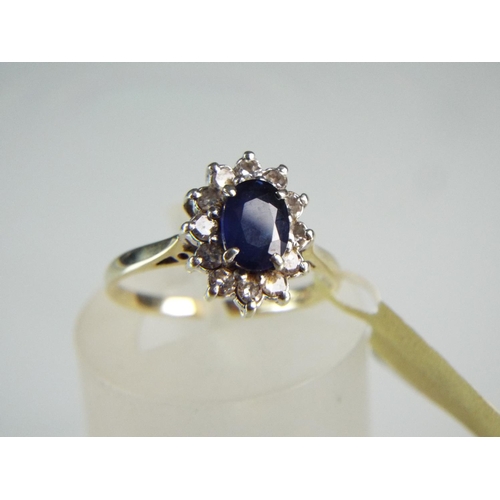 78 - 9ct Oval cut solitaire Sapphire with 12 surrounding Diamonds. Finger size 'N5'   2.3g