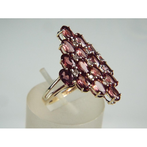 95 - 9ct Multi Garnet set ring in Diamond shaped pattern. Finger size 'O5'    3.4g