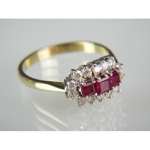 130 - 18ct Yellow Gold Triple Ruby set ring surrounded by 12 Diamonds. Finger size 'P5-Q'    3.7g