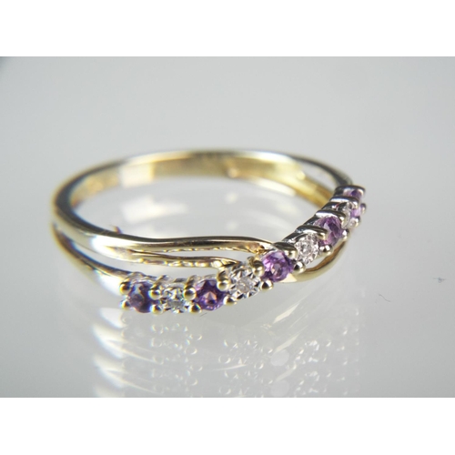 138 - 9ct Gold Diamond and Tanzanite set X over ring.  Finger size M5-N  1.5g