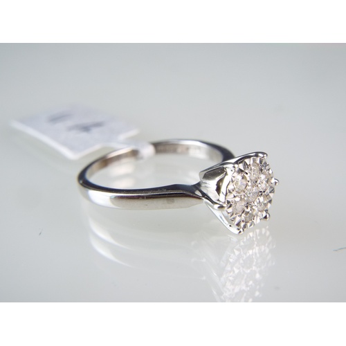 155 - 9ct White gold Diamond cluster ring set in a flower pattern.   0.25 Diamonds   Finger size 'M' 3.1g