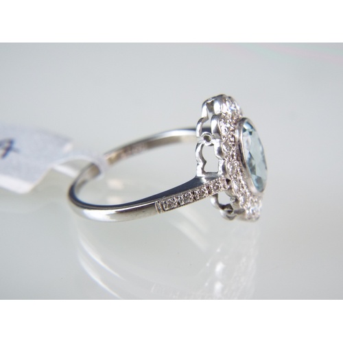 152 - 18ct White gold ring set with lovely Aquamarine oval stone surrounded by Diamonds. Aquamarine = 1ct ... 