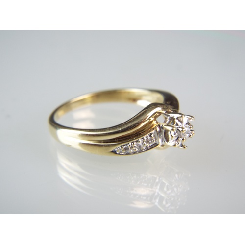 129 - 9ct Gold Illusion set Diamond ring set with three Diamonds to each shoulder.   Approx 0.25cts of Dia... 