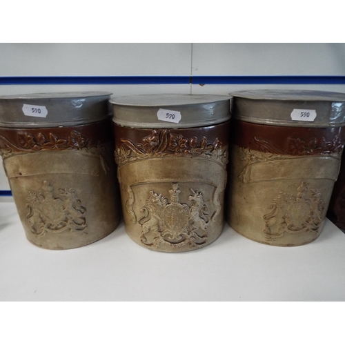 590 - Three 19th Century stoneware jars with amorial decoration. Each with close fitting metal lids.