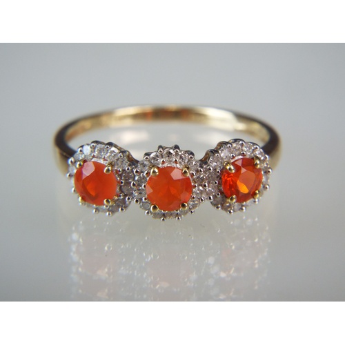 134A - Three Stone Mexican fire Opal & Diamond ring set into a 9ct Yellow gold mount.  Approx 0.40 points o... 