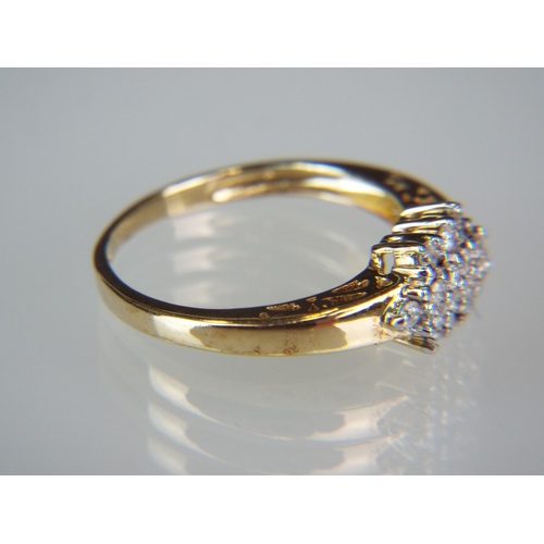 140A - 9ct Yellow Gold ring set with approx 0.25pts of African White Diamonds in a cluster pattern. 
Finger... 