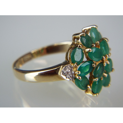 141A - Beautiful Emerald and Diamond ring arranged in an open Daisy design. Set in a 9ct Yellow gold mount.... 