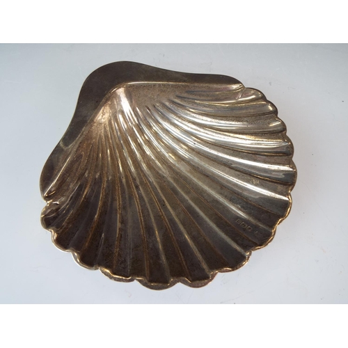 227 - Scallop shell Silver serving dish standing on three bun feet.  5 inches wide. Sheffield 1912   78g  ... 