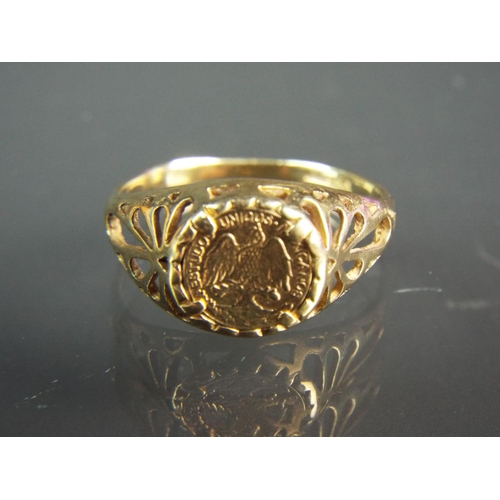 132 - 9ct Yellow gold ring with scrolled and pierced shoulders set with a gold Equador coin.  Finger size ... 