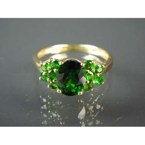 140 - Large 9ct yellow gold ring set with large Russian oval Diopside surrounded by smaller gems to each s... 