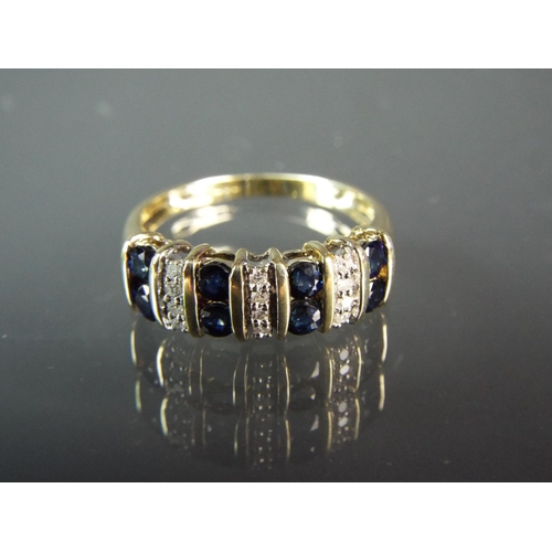 155 - Large 9ct Yellow gold ring set with Twelve Diamonds and Eight Sapphires in a bar pattern.  Finger si... 